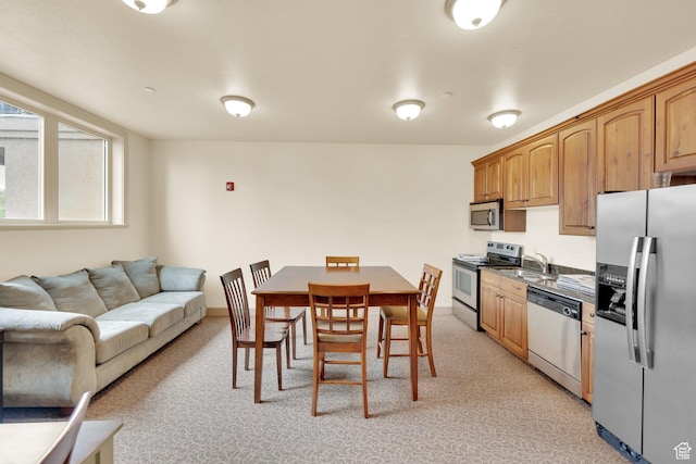 2011 S 2100 E Unit 308, Salt Lake City, UT 84108 - kitchen with stainless steel appliances, a sink, open floor plan, and light colored carpet