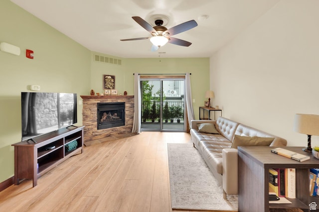 2011 S 2100 E Unit 308, Salt Lake City, UT 84108 - living area featuring wood finished floors, a ceiling fan, and a fireplace