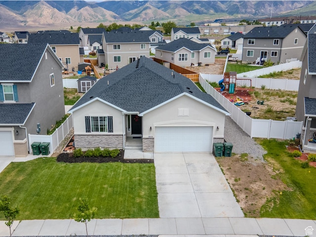 1622 N Baen Way E, Tooele, UT 84074 - view of front of home featuring stucco siding, a garage, a residential view, and a mountain view