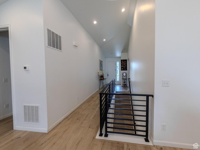 1622 N Baen Way E, Tooele, UT 84074 - hallway featuring light wood finished floors, recessed lighting, baseboards, an upstairs landing, and high vaulted ceiling
