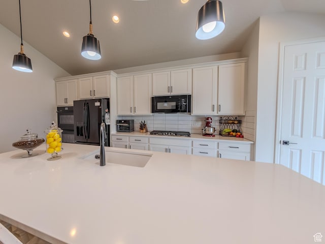 1622 N Baen Way E, Tooele, UT 84074 - kitchen with black appliances, a sink, lofted ceiling, backsplash, and white cabinetry