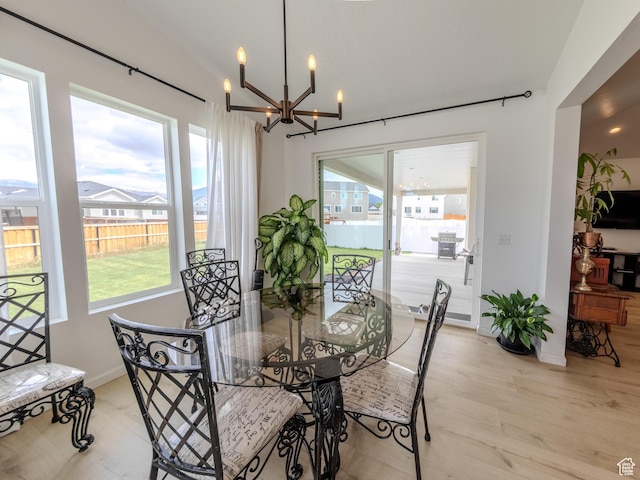 1622 N Baen Way E, Tooele, UT 84074 - dining space featuring a chandelier, wood finished floors, and baseboards