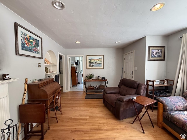 living room with light wood finished floors and recessed lighting