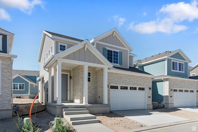 view of front facade featuring board and batten siding, an attached garage, concrete driveway, and stone siding