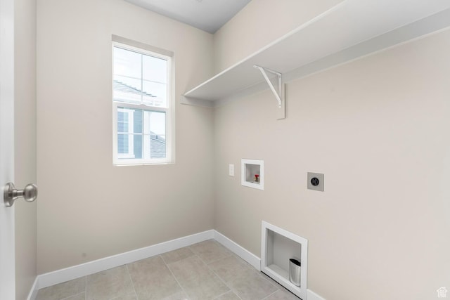 washroom featuring electric dryer hookup, washer hookup, baseboards, and light tile patterned flooring
