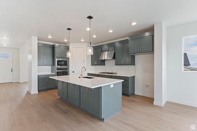 1431 E Beechwood Dr, Layton, UT 84040 - kitchen featuring a sink, stainless steel appliances, light wood finished floors, under cabinet range hood, and decorative backsplash