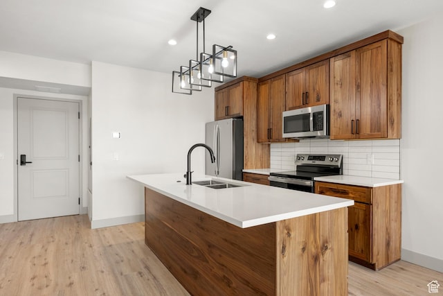 kitchen with stainless steel appliances, brown cabinets, baseboards, and recessed lighting