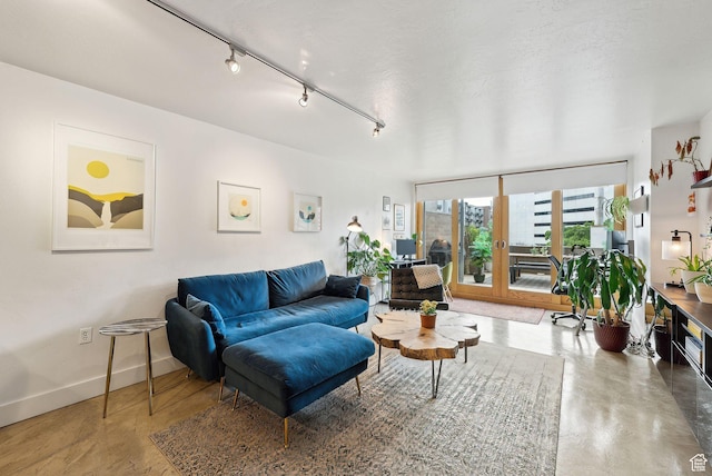 230 E Broadway E Unit 403, Salt Lake City, UT 84111 - living room featuring baseboards, finished concrete flooring, and track lighting
