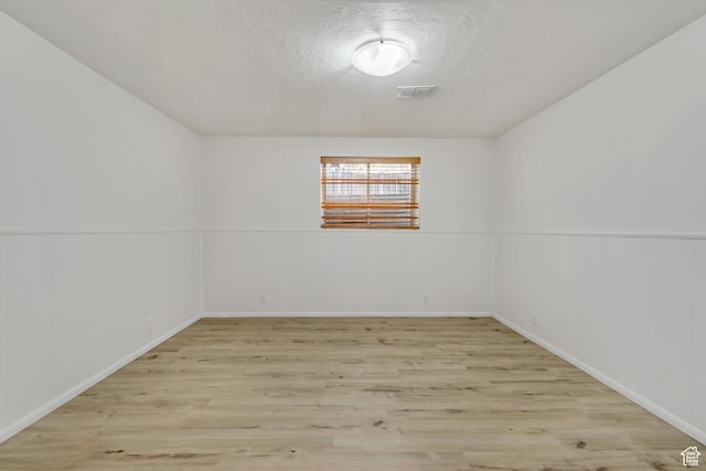 3236 W New World Dr S, West Jordan, UT 84084 - empty room with light wood finished floors, a textured ceiling, and baseboards