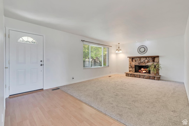 3236 W New World Dr S, West Jordan, UT 84084 - unfurnished living room featuring baseboards, a fireplace, wood finished floors, and carpet floors