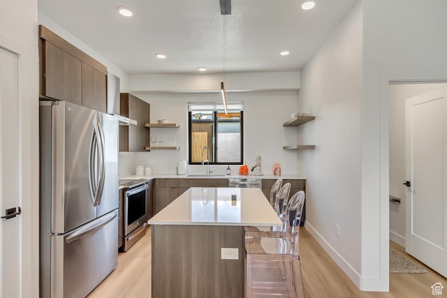 4186 S Main St Unit N220, Millcreek, UT 84107 - kitchen featuring appliances with stainless steel finishes, open shelves, a sink, light wood-type flooring, and modern cabinets
