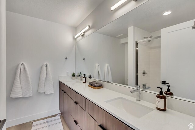 4186 S Main St Unit N220, Millcreek, UT 84107 - bathroom with a shower stall, baseboards, double vanity, recessed lighting, and wood finished floors