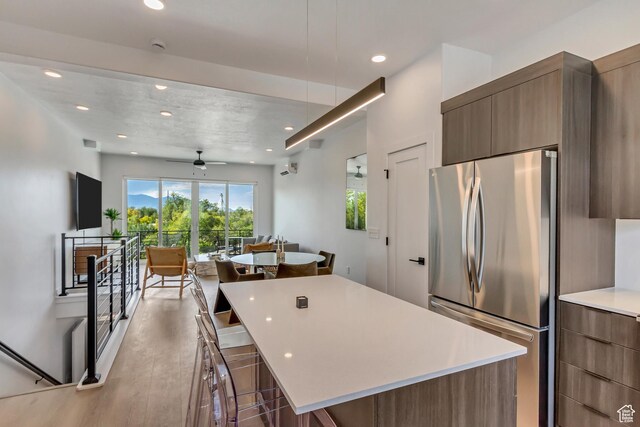 4186 S Main St Unit N220, Millcreek, UT 84107 - kitchen featuring freestanding refrigerator, modern cabinets, a center island, recessed lighting, and light countertops