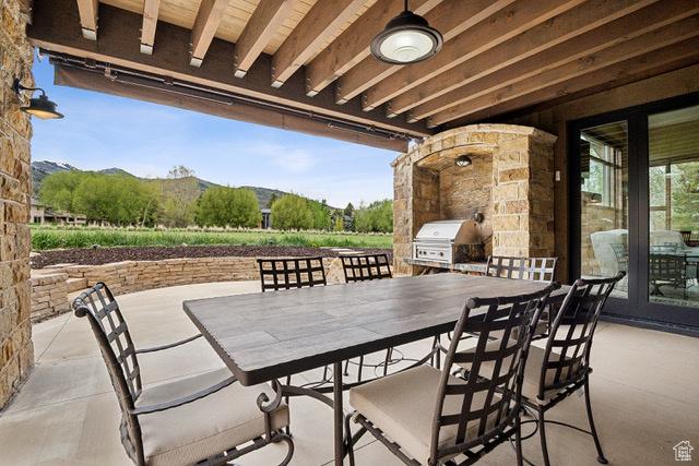 4891 Last Stand Dr, Snyderville, UT 84098 - view of patio with a grill, outdoor dining area, and a mountain view
