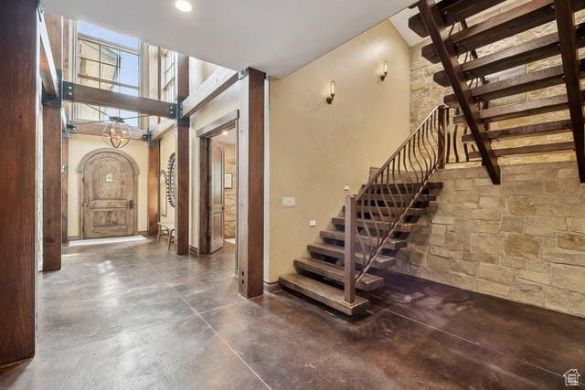 4891 Last Stand Dr, Snyderville, UT 84098 - staircase featuring concrete flooring and arched walkways