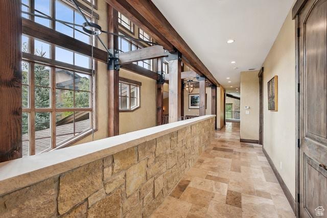 4891 Last Stand Dr, Snyderville, UT 84098 - hallway with stone tile floors, baseboards, recessed lighting, and plenty of natural light