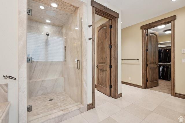 4891 Last Stand Dr, Snyderville, UT 84098 - bathroom featuring a marble finish shower, baseboards, tile patterned flooring, a walk in closet, and recessed lighting