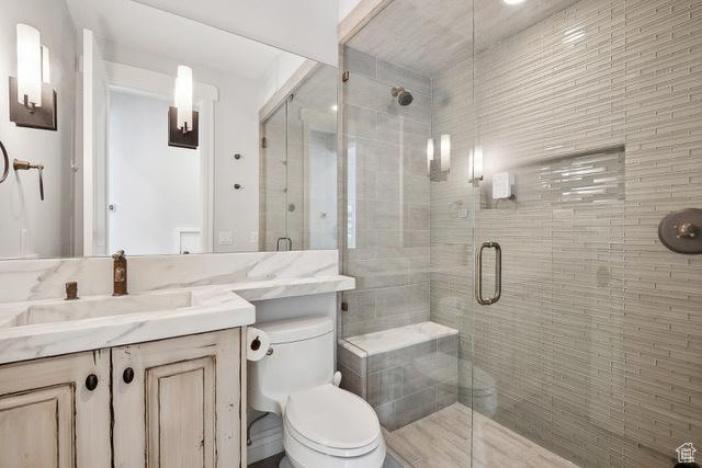 4891 Last Stand Dr, Snyderville, UT 84098 - bathroom featuring toilet, vanity, and a shower stall