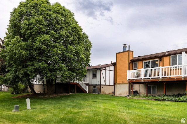 1180 W Middlesex Rd S, Taylorsville, UT 84123 - back of house featuring central AC unit, a wooden deck, a yard, and stairway
