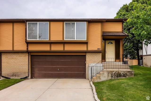 1180 W Middlesex Rd S, Taylorsville, UT 84123 - view of front facade featuring brick siding, an attached garage, driveway, and a front yard