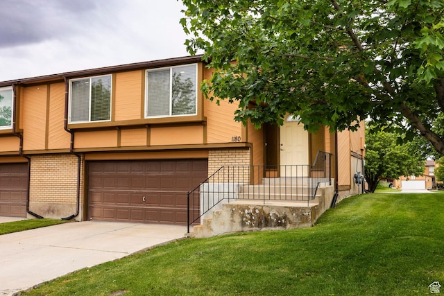 1180 W Middlesex Rd S, Taylorsville, UT 84123 - view of front of house with an attached garage, brick siding, driveway, and a front lawn