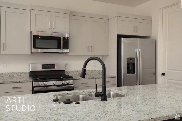 4883 N 10 E, Enoch, UT 84721 - kitchen featuring stainless steel appliances, a sink, light stone counters, and white cabinets