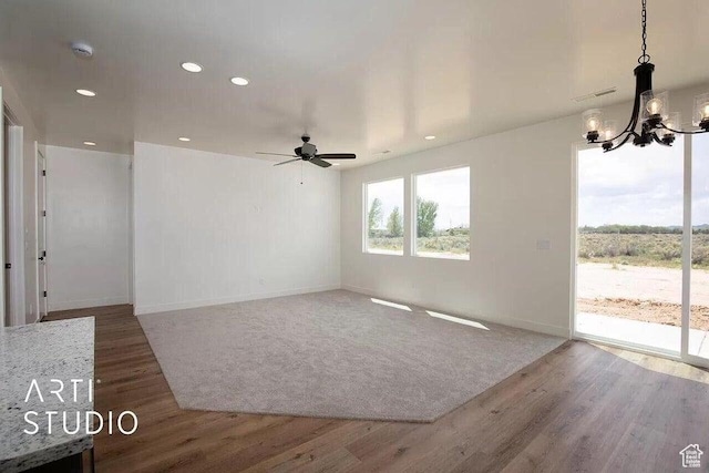 4883 N 10 E, Enoch, UT 84721 - unfurnished living room with a chandelier, ceiling fan, wood finished floors, recessed lighting, and baseboards