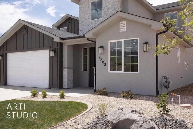 4883 N 10 E, Enoch, UT 84721 - view of front of property featuring a garage, board and batten siding, stucco siding, stone siding, and concrete driveway