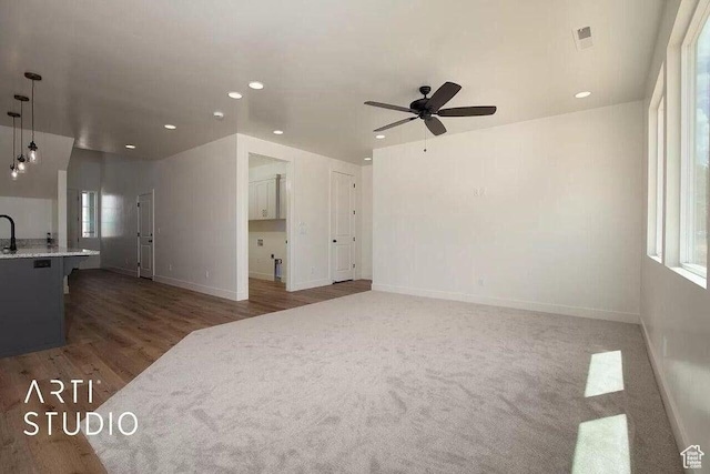 4883 N 10 E, Enoch, UT 84721 - unfurnished living room with ceiling fan, recessed lighting, baseboards, wood finished floors, and a sink