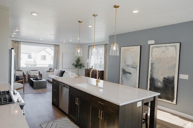 kitchen featuring a sink, dishwasher, dark wood finished floors, open floor plan, and recessed lighting