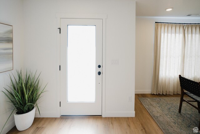foyer entrance featuring wood finished floors and baseboards