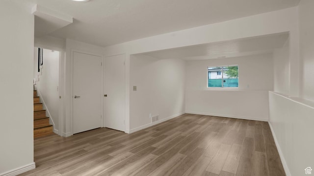 2976 S Laree St, West Valley City, UT 84120 - spare room with light wood-style flooring, baseboards, and stairway