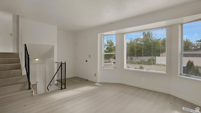 2976 S Laree St, West Valley City, UT 84120 - unfurnished room featuring plenty of natural light, baseboards, stairway, and wood finished floors