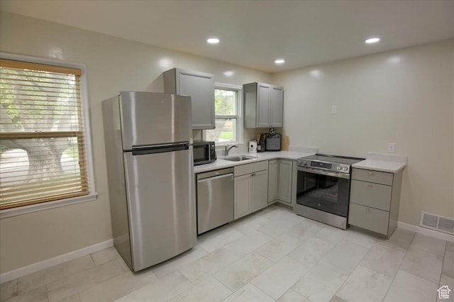 708 Robins Ave, Ogden, UT 84404 - kitchen featuring appliances with stainless steel finishes, gray cabinetry, light countertops, baseboards, and recessed lighting