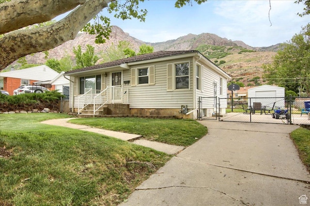 708 Robins Ave, Ogden, UT 84404 - view of front of house with a gate, a mountain view, driveway, and a detached garage