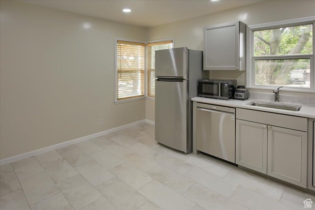 708 Robins Ave, Ogden, UT 84404 - kitchen featuring appliances with stainless steel finishes, a sink, gray cabinetry, plenty of natural light, and recessed lighting