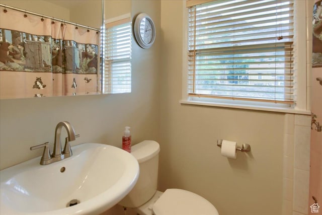 708 Robins Ave, Ogden, UT 84404 - full bathroom featuring a sink, toilet, healthy amount of natural light, and a shower with curtain