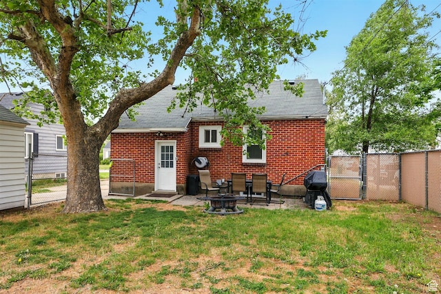 575 5th St, Ogden, UT 84404 - back of property with a gate, roof with shingles, brick siding, and a patio area