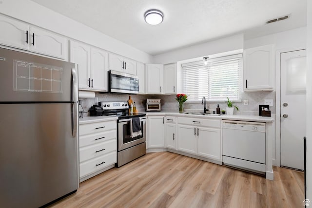 88 W 50 S Unit L5, Centerville, UT 84014 - kitchen featuring stainless steel appliances, a sink, white cabinetry, and decorative backsplash