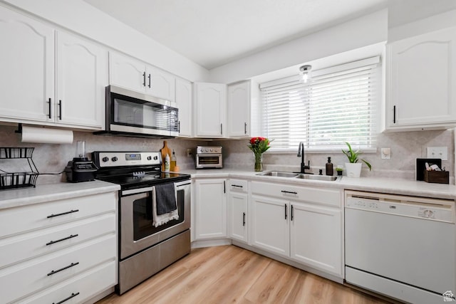 88 W 50 S Unit L5, Centerville, UT 84014 - kitchen featuring appliances with stainless steel finishes, a sink, white cabinets, and tasteful backsplash
