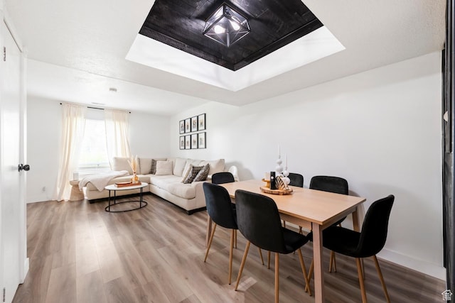 88 W 50 S Unit L5, Centerville, UT 84014 - dining room featuring a raised ceiling, wood finished floors, and baseboards