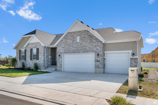 5667 N Parkview Dr, Stansbury Park, UT 84074 - craftsman house featuring a garage, driveway, and stone siding