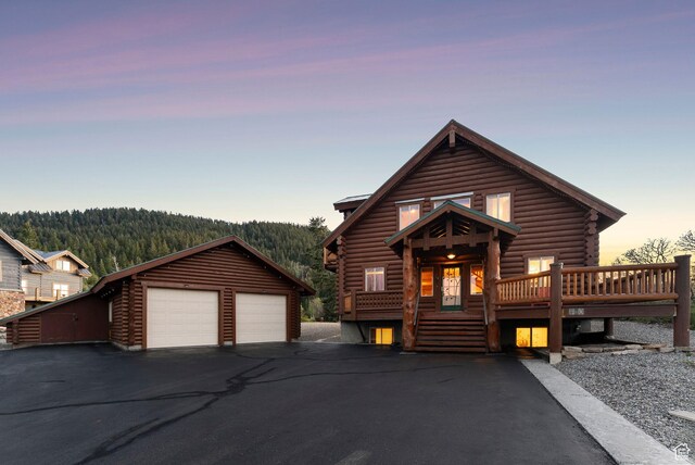 450 Crestview Dr, Summit Park, UT 84098 - cabin with log siding, a detached garage, an outdoor structure, and a forest view