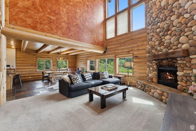 450 Crestview Dr, Summit Park, UT 84098 - carpeted living area featuring a towering ceiling, log walls, a fireplace, healthy amount of natural light, and beamed ceiling