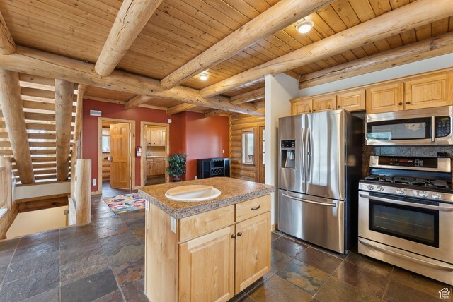 450 Crestview Dr, Summit Park, UT 84098 - kitchen with appliances with stainless steel finishes, light brown cabinets, a center island, stone tile flooring, and wooden ceiling with exposed beams