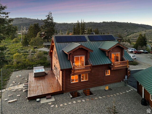450 Crestview Dr, Summit Park, UT 84098 - back of property at dusk featuring log siding, a deck with mountain view, and metal roof
