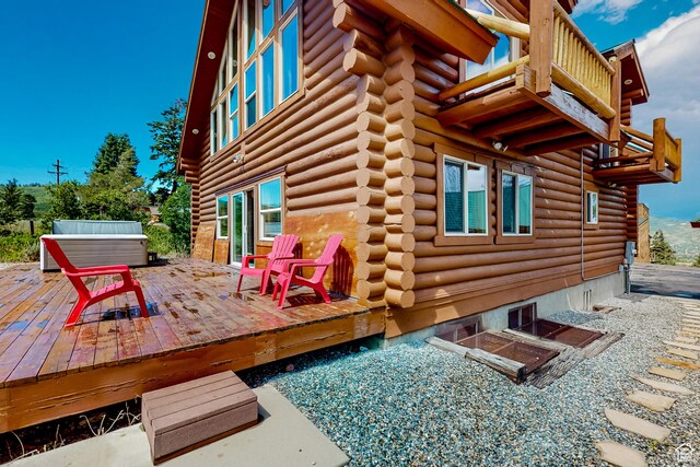450 Crestview Dr, Summit Park, UT 84098 - view of side of home featuring log siding, a covered hot tub, a wooden deck, and a balcony