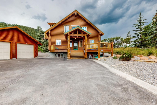 450 Crestview Dr, Summit Park, UT 84098 - cabin with log exterior, a deck, an outdoor structure, and a garage