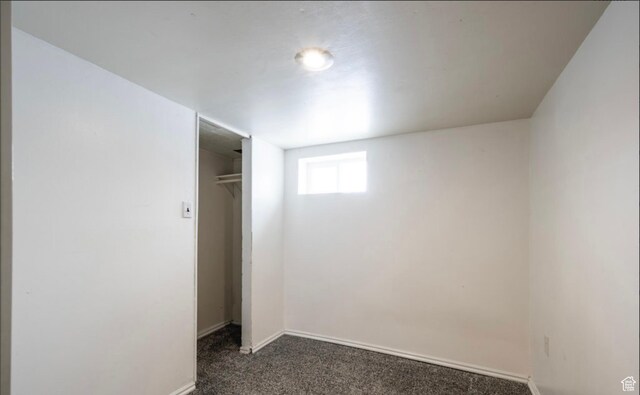 463 Vine St, Clearfield, UT 84015 - unfurnished bedroom with dark carpet, baseboards, and a closet