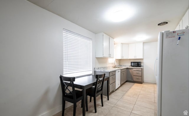 463 Vine St, Clearfield, UT 84015 - kitchen featuring white appliances, a sink, white cabinets, light tile patterned floors, and light stone countertops